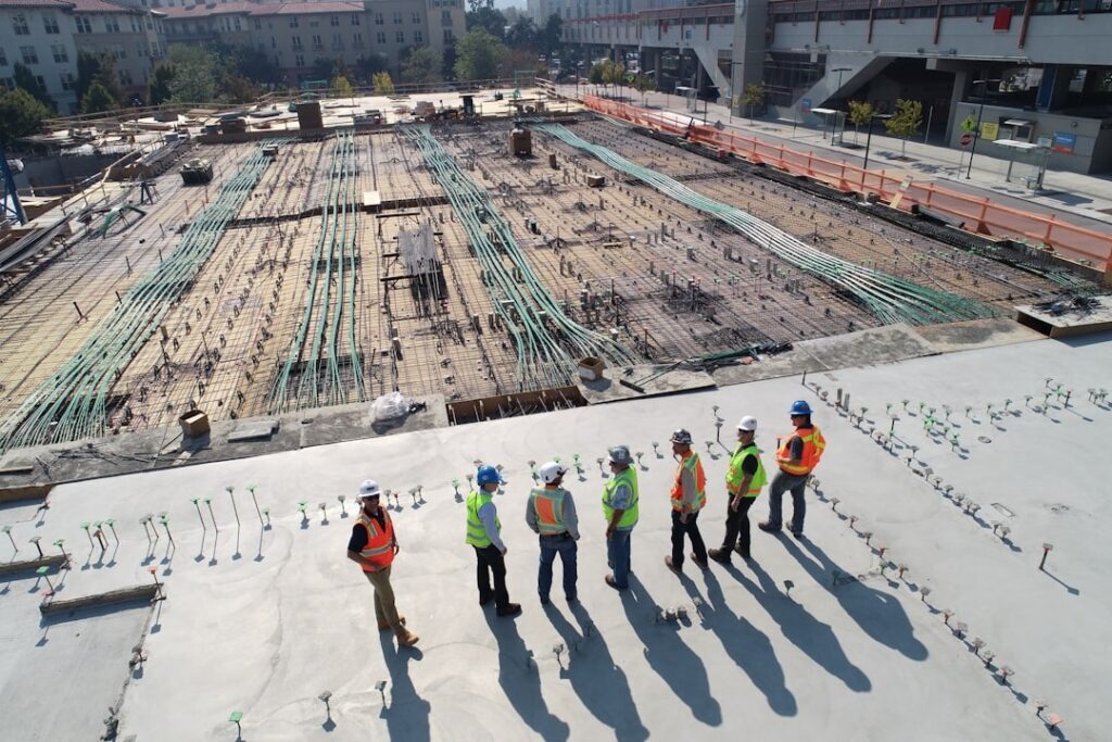 Construction team reviewing building plans on site