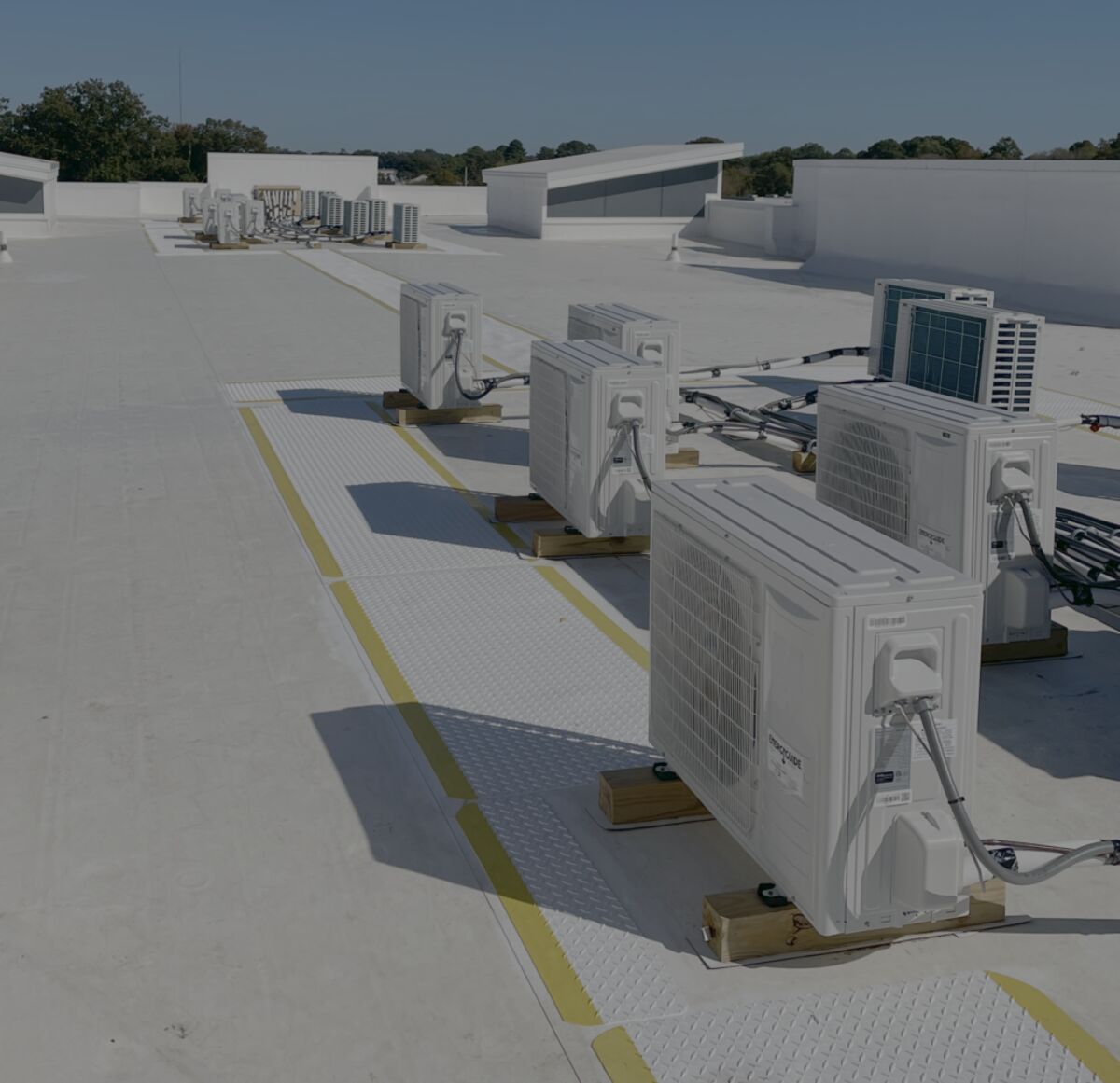 Rooftop HVAC condensing units on a commercial building